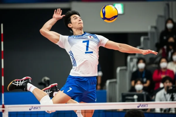 Pemain voli pria sedang melompat dengan sepatu asics yang stabil